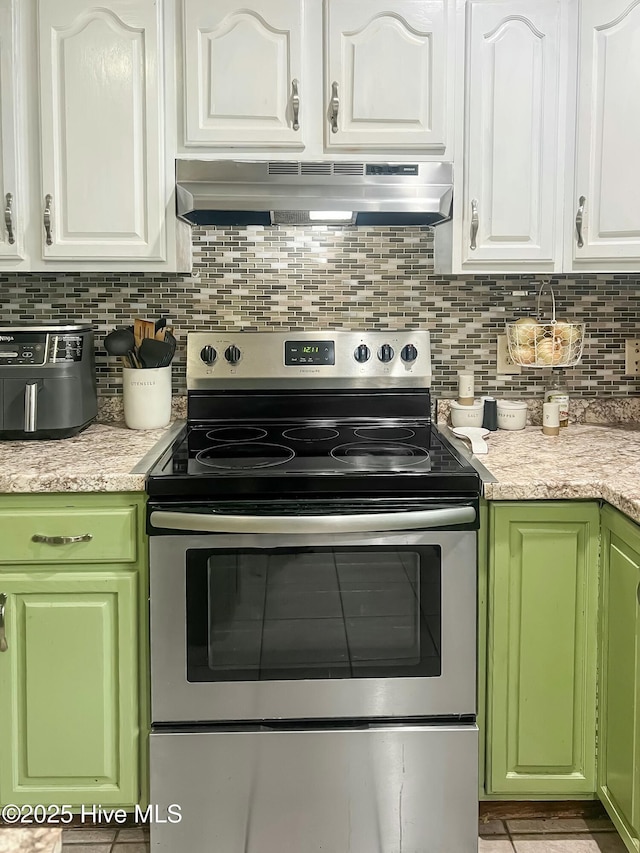 kitchen with ventilation hood, white cabinetry, decorative backsplash, and electric stove