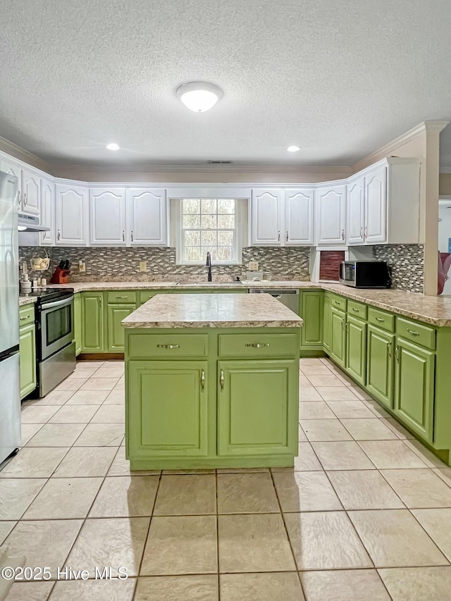 kitchen with appliances with stainless steel finishes, green cabinets, white cabinetry, sink, and light tile patterned floors