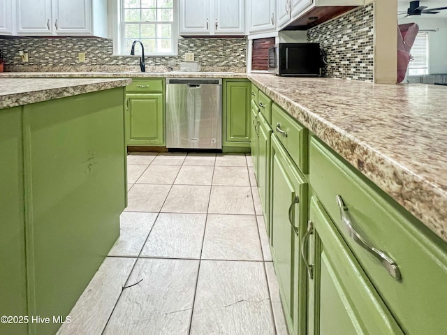 kitchen with stainless steel dishwasher, white cabinets, backsplash, and light tile patterned floors