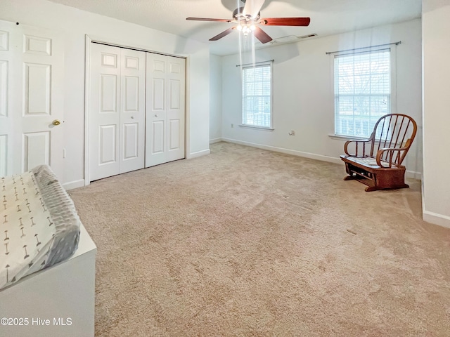 sitting room featuring light carpet and ceiling fan