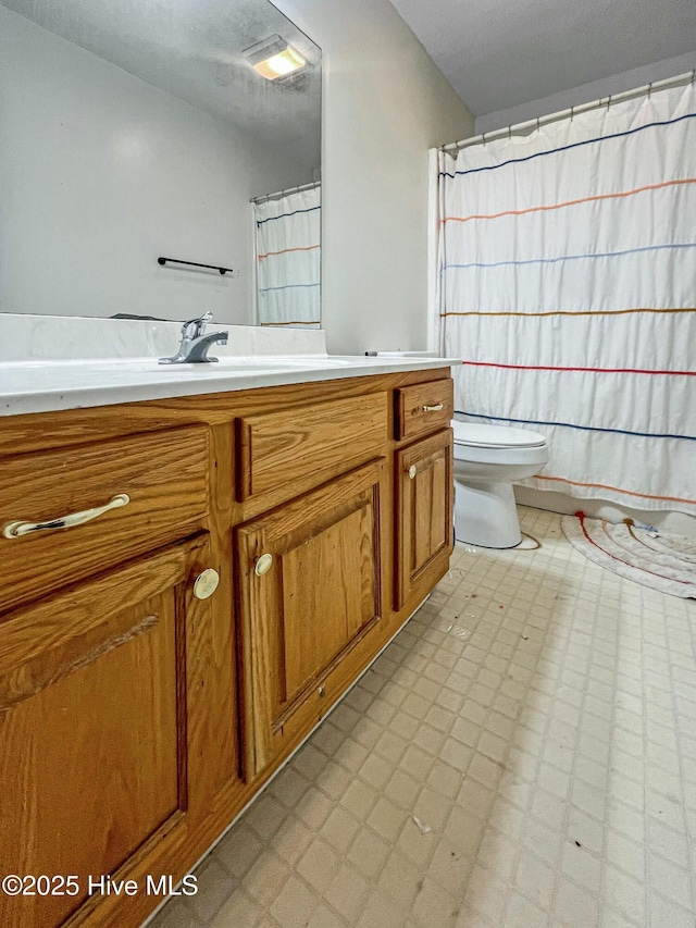 bathroom featuring toilet and vanity