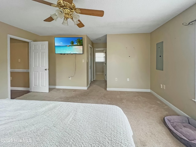 unfurnished bedroom with light carpet, ceiling fan, and electric panel