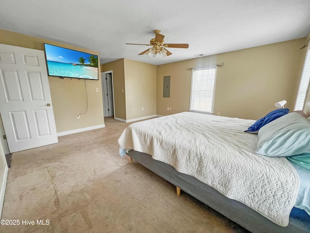 bedroom with ceiling fan, a textured ceiling, electric panel, and light carpet