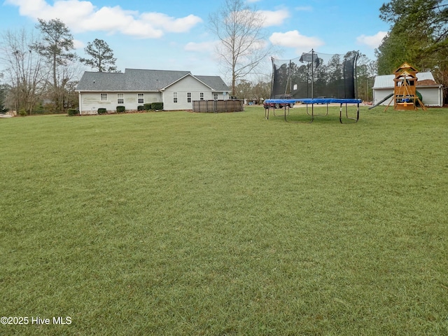 view of yard featuring a playground, a trampoline, and a swimming pool