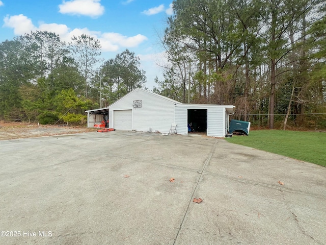 garage featuring a lawn and a carport