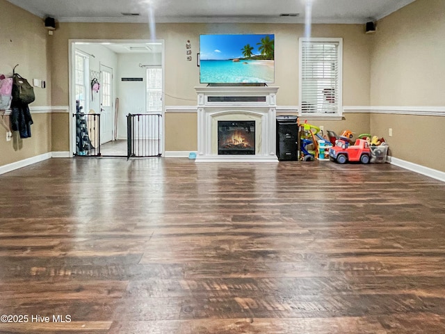 living room featuring dark hardwood / wood-style flooring and ornamental molding