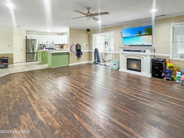 unfurnished living room with light hardwood / wood-style floors and ceiling fan