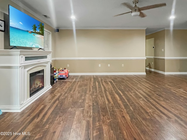 unfurnished living room featuring hardwood / wood-style flooring, crown molding, and ceiling fan