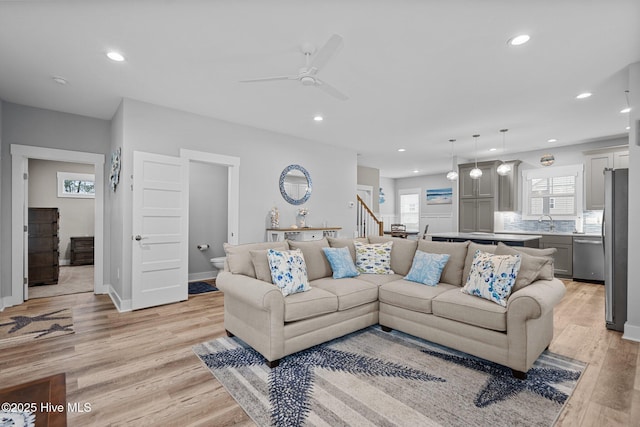 living room with recessed lighting, stairway, light wood-style floors, baseboards, and ceiling fan