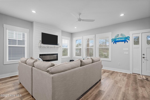 245 NE 64th St, Oak Island, NC 28465 - living room with a ceiling fan, plenty of natural light, a fireplace, light wood finished floors, and recessed lighting