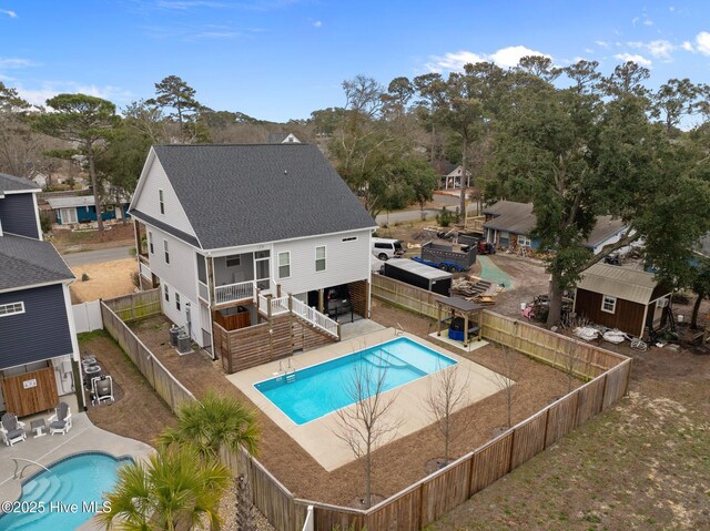 245 NE 64th St, Oak Island, NC 28465 - rear view of property with a fenced backyard, a shingled roof, stairway, and a patio area