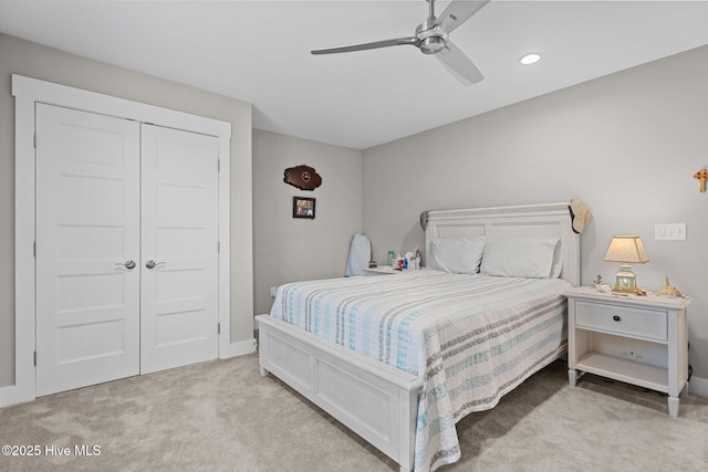 bedroom featuring a ceiling fan, a closet, light carpet, baseboards, and recessed lighting