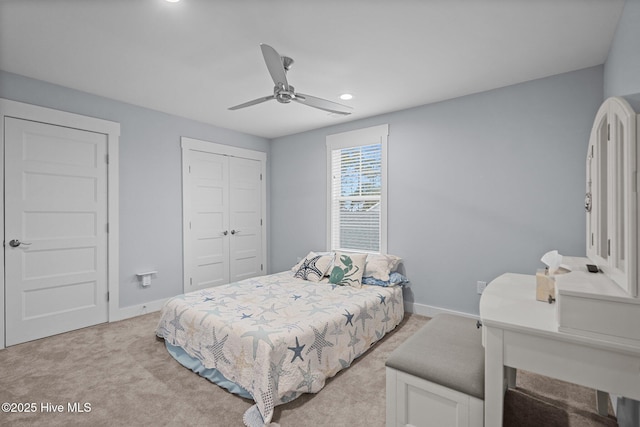 bedroom with recessed lighting, a ceiling fan, light carpet, a closet, and baseboards