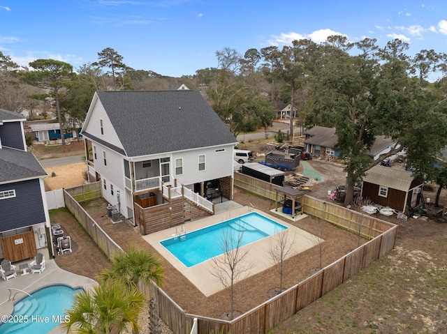 exterior space with stairway, a fenced backyard, a fenced in pool, and a patio