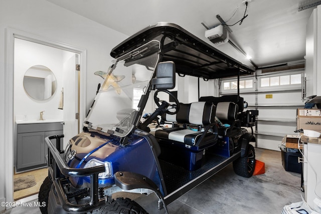 garage featuring a sink and a garage door opener