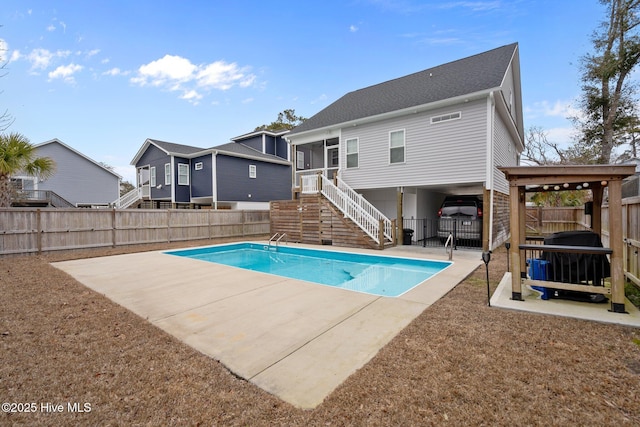 view of pool with a fenced in pool, a patio, a fenced backyard, and stairs