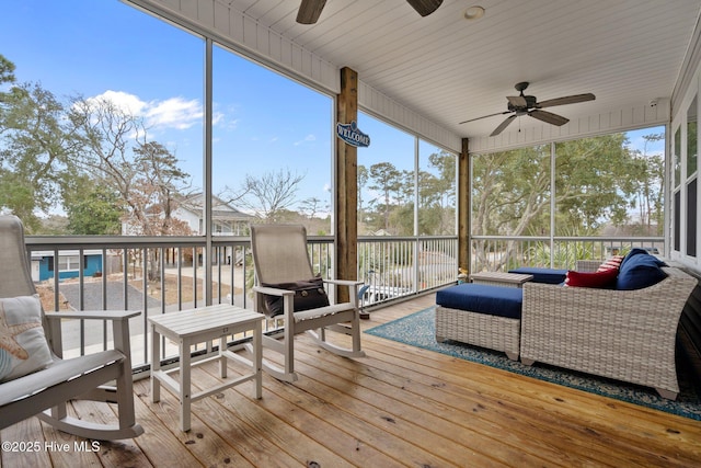 sunroom featuring an outdoor hangout area and ceiling fan