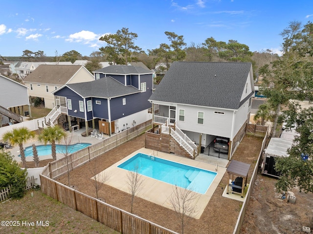 view of pool with a fenced backyard, a patio, stairs, and a fenced in pool