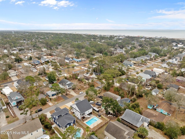 drone / aerial view with a water view and a residential view