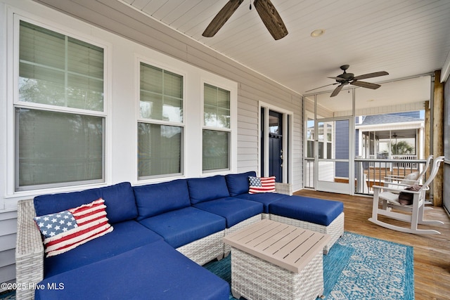 sunroom featuring ceiling fan and outdoor lounge area