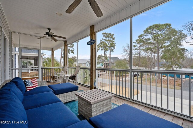 245 NE 64th St, Oak Island, NC 28465 - sunroom featuring a ceiling fan, outdoor lounge area, and a residential view