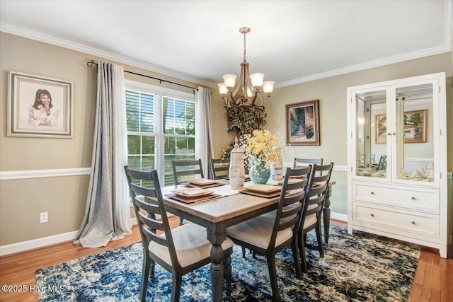 dining room featuring crown molding, a chandelier, and light hardwood / wood-style floors