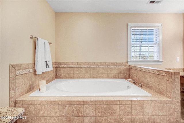 bathroom with a relaxing tiled tub and vanity