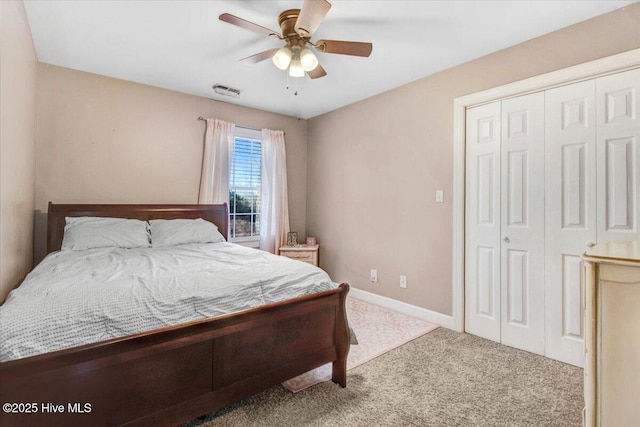 carpeted bedroom featuring ceiling fan and a closet