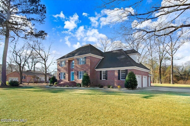 view of front of property featuring a garage and a front lawn