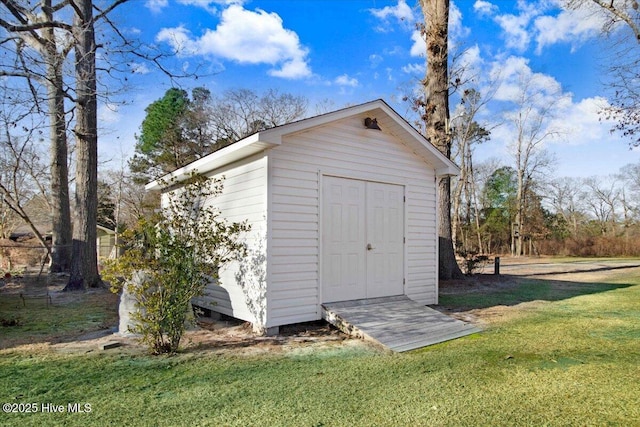 view of outbuilding with a lawn