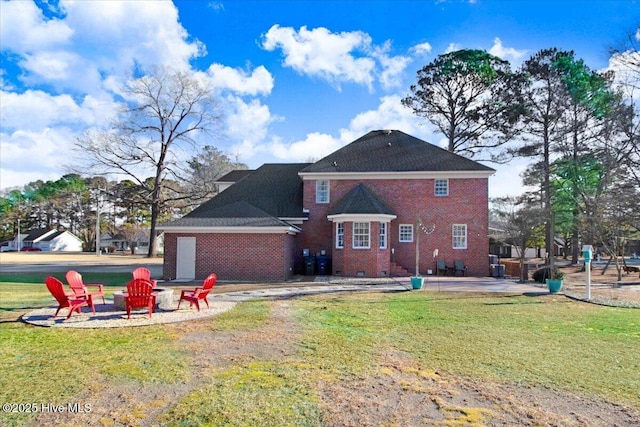 rear view of property with a patio area, a lawn, and a fire pit