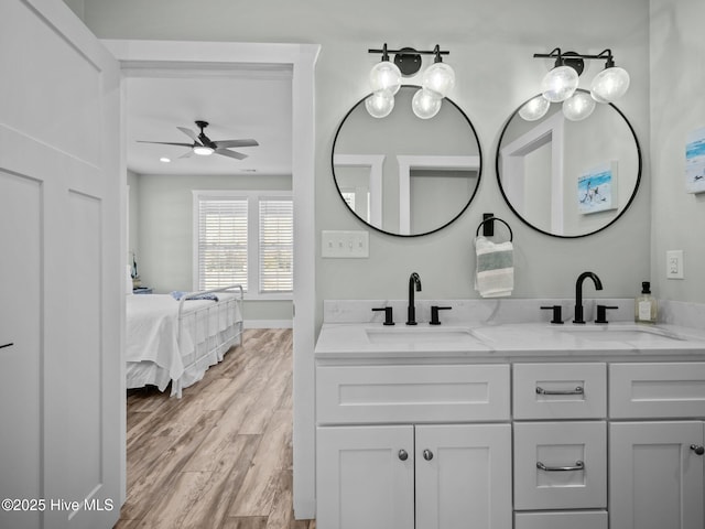 bathroom with ceiling fan, wood-type flooring, and vanity