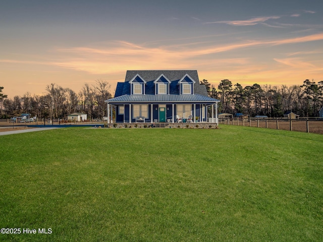 view of front of house with covered porch and a lawn