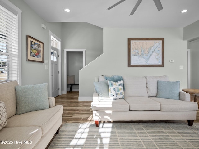 living room featuring ceiling fan and hardwood / wood-style flooring