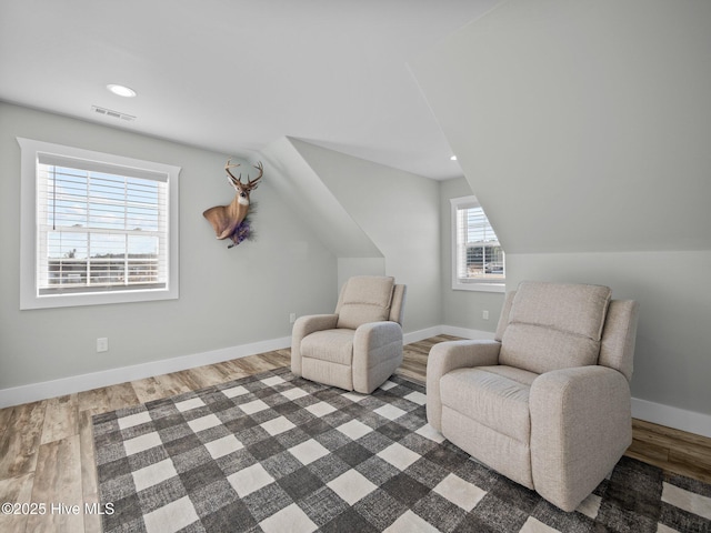 sitting room featuring vaulted ceiling and hardwood / wood-style flooring