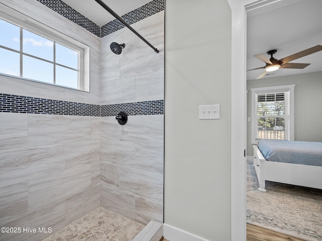 bathroom featuring ceiling fan and a tile shower