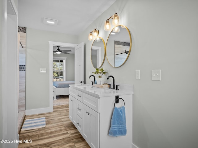 bathroom featuring ceiling fan, hardwood / wood-style flooring, and vanity