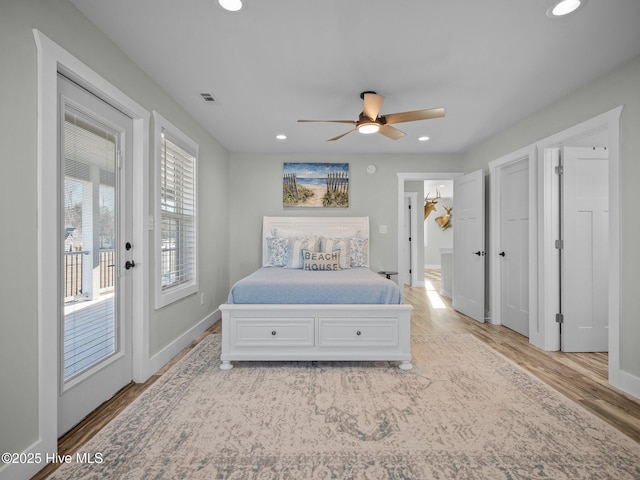 bedroom featuring ceiling fan, light hardwood / wood-style flooring, and access to outside