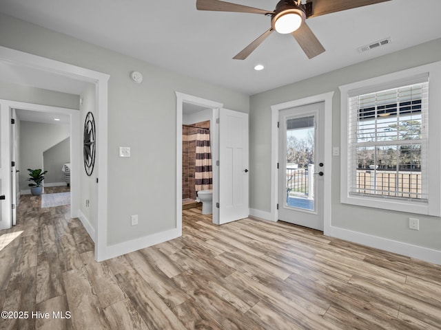 spare room featuring ceiling fan and light hardwood / wood-style flooring