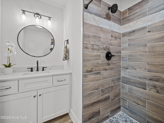 bathroom featuring vanity and tiled shower