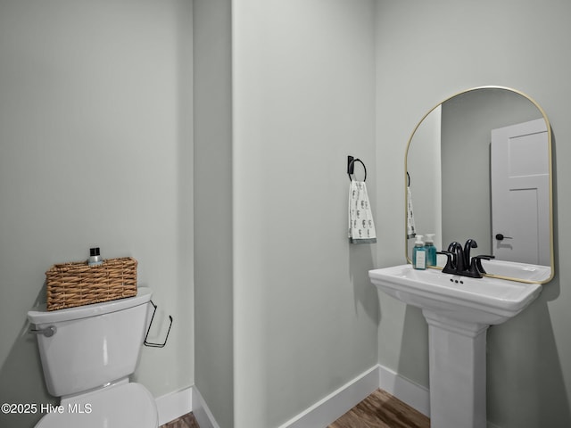 bathroom featuring toilet and hardwood / wood-style flooring