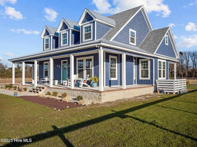 cape cod-style house featuring a front yard and a porch