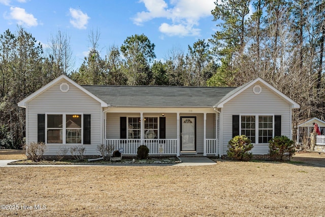 ranch-style house featuring a porch and a front lawn