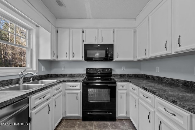 kitchen with sink, white cabinetry, black appliances, a textured ceiling, and dark tile patterned flooring