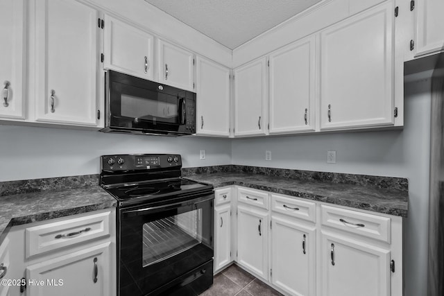 kitchen with white cabinets, dark tile patterned flooring, a textured ceiling, and black appliances