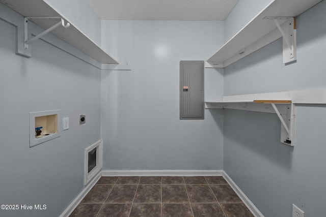 washroom with electric panel, washer hookup, a textured ceiling, dark tile patterned flooring, and hookup for an electric dryer