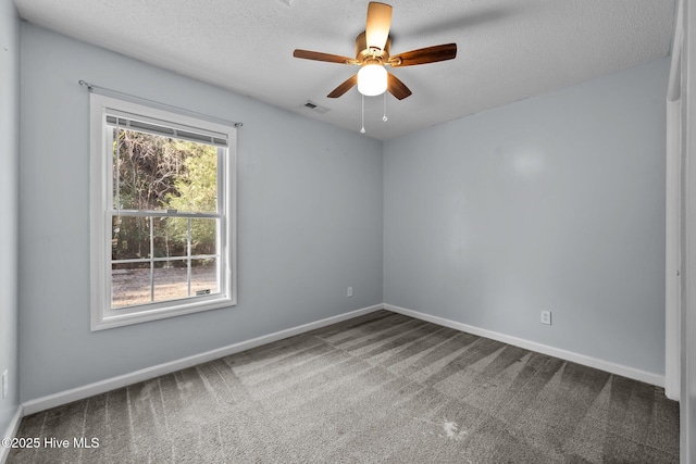 spare room featuring ceiling fan, carpet floors, and a textured ceiling