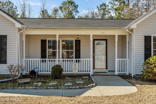 entrance to property featuring covered porch