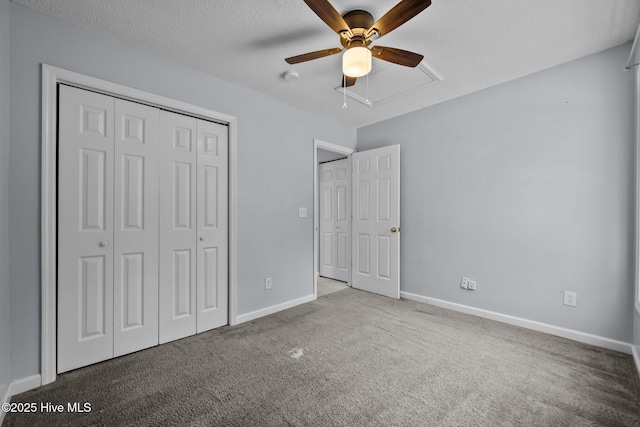 unfurnished bedroom featuring ceiling fan, a closet, a textured ceiling, and carpet flooring