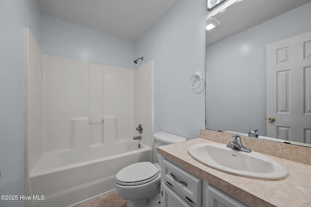 full bathroom featuring vanity, tile patterned floors, toilet, and washtub / shower combination